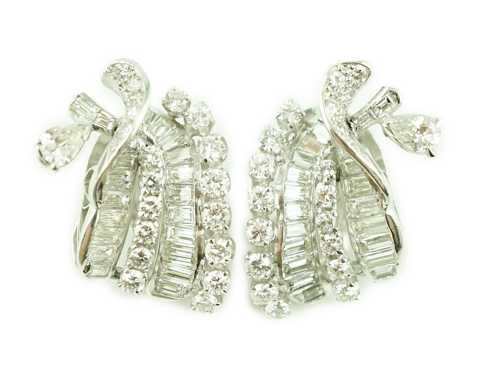 A pair of platinum and round cut, baguette cut and pear cut diamond cluster set scrolling ear clips